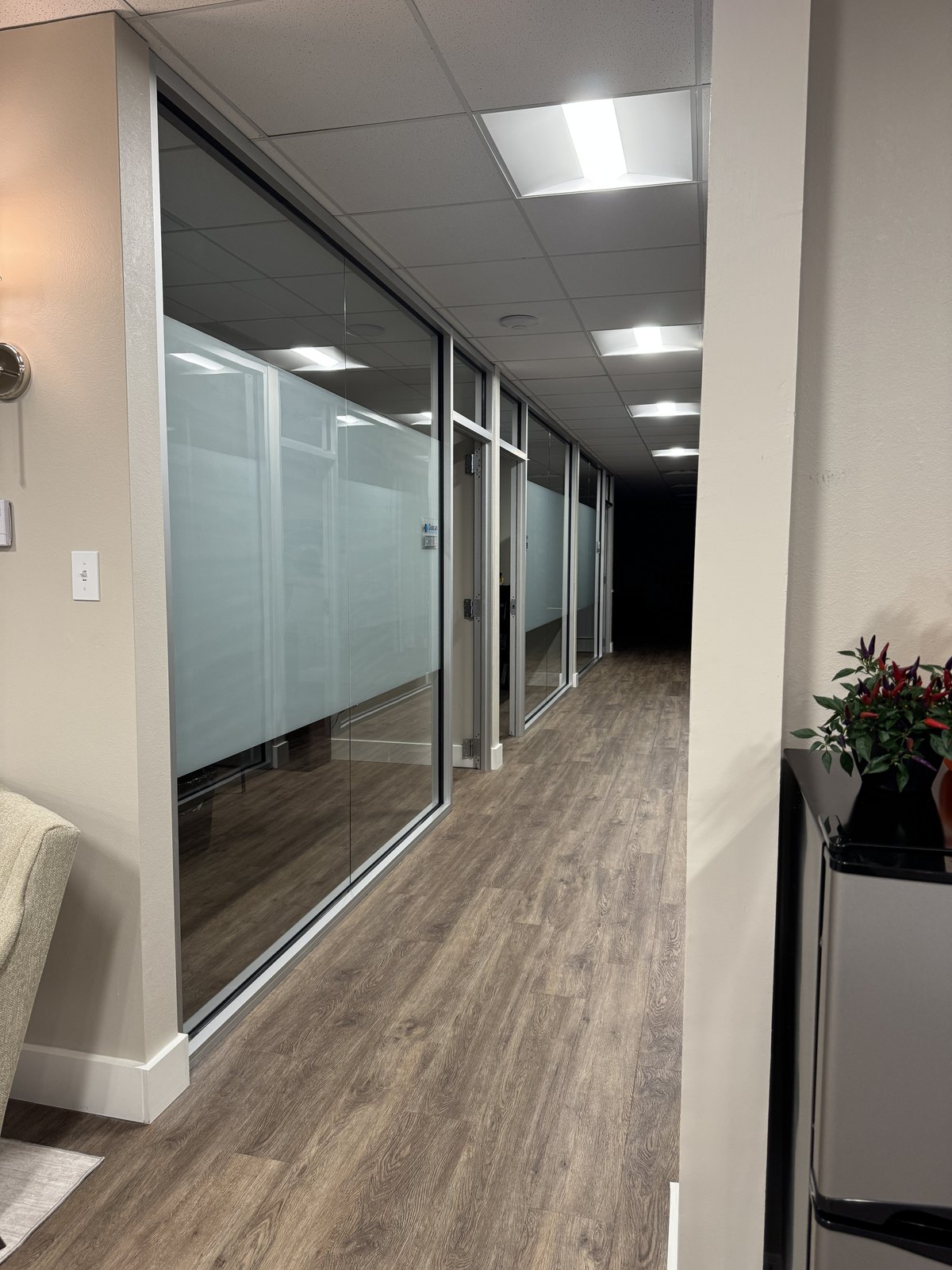 Office hallway glass with frosted privacy film installed by Threshold Window Film
