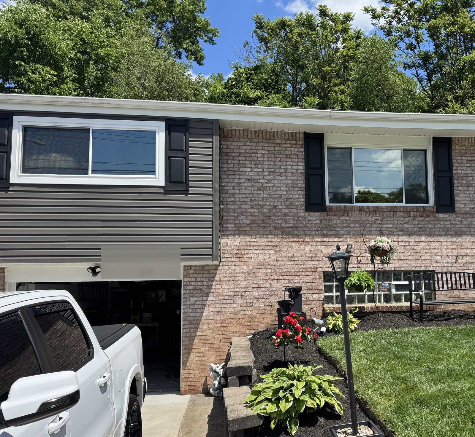 Brick home with reflective solar window film on front windows — daytime privacy and heat control by Threshold